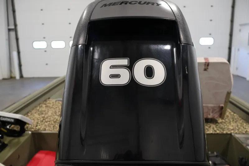 Slide: The Image of 2014 Lowe Roughneck 1756 with Mercury 60 horsepower outboard motor in a garage setting. - 30