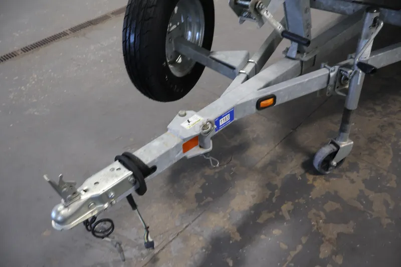 Slide: The Image of Trailer hitch of a 2014 Lowe Roughneck 1756 boat, featuring a sturdy wheel assembly. - 32