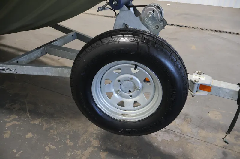 Slide: The Image of Trailer wheel of a 2014 Lowe Roughneck 1756 boat on concrete floor. - 33