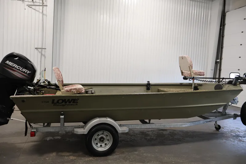 Slide: The Image of 2014 Lowe Roughneck 1756 boat on trailer with Mercury outboard motor in garage. - 4