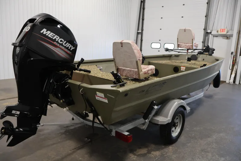 Slide: The Image of 2014 Lowe Roughneck 1756 boat with Mercury outboard motor in a garage setting. - 5