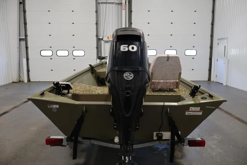 Slide: The Image of 2014 Lowe Roughneck 1756 boat with Mercury 60 engine in a garage setting. - 6