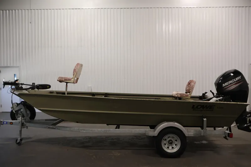 Slide: The Image of 2014 Lowe Roughneck 1756 boat on trailer with Mercury outboard motor in indoor setting. - 8