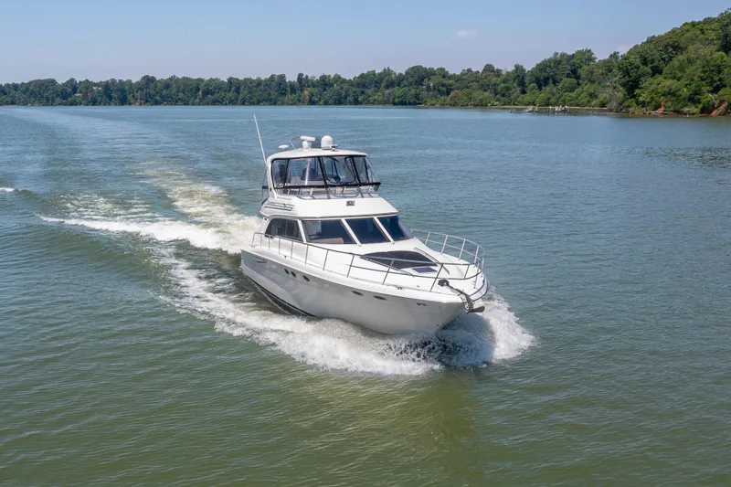 The Image of 2003 Sea Ray 480 Sedan Bridge cruising on a calm river. - 0