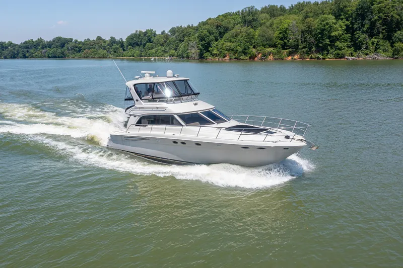 Slide: The Image of 2003 Sea Ray 480 Sedan Bridge cruising on a calm river. - 1