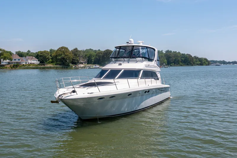 Slide: The Image of 2003 Sea Ray 480 Sedan Bridge on calm waters. - 11