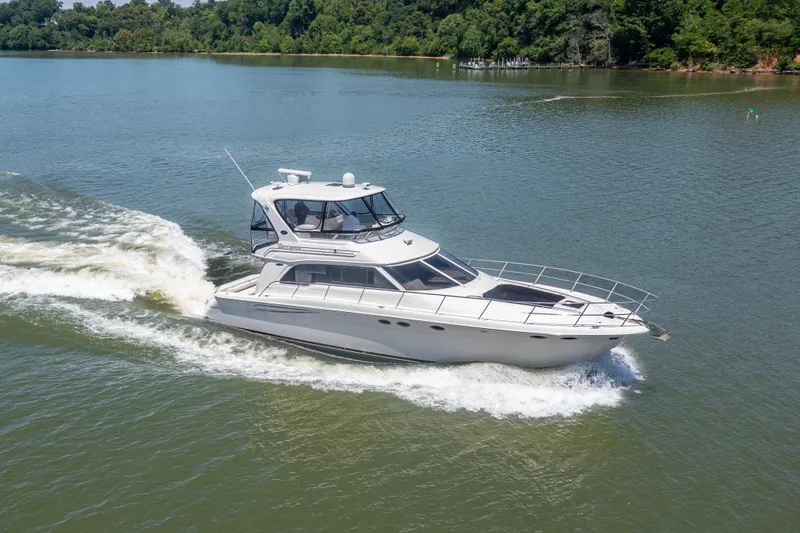 Slide: The Image of 2003 Sea Ray 480 Sedan Bridge cruising on a calm lake. - 12