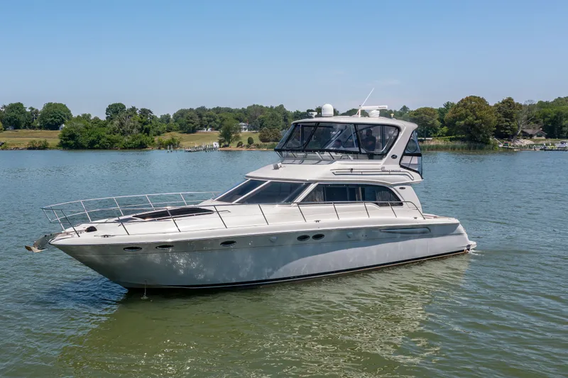 Slide: The Image of 2003 Sea Ray 480 Sedan Bridge on calm water. - 13