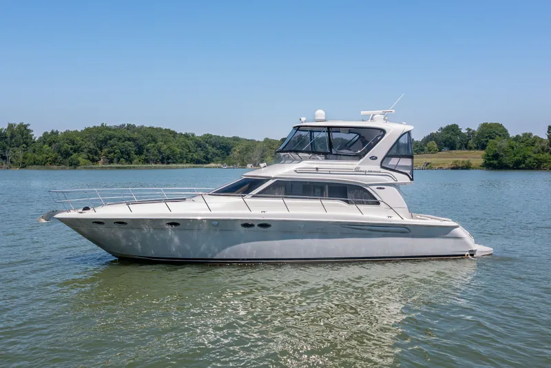 Slide: The Image of 2003 Sea Ray 480 Sedan Bridge on calm water. - 14