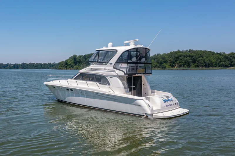 Slide: The Image of 2003 Sea Ray 480 Sedan Bridge on calm waters. - 15
