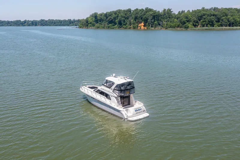 Slide: The Image of 2003 Sea Ray 480 Sedan Bridge on calm waters. - 16