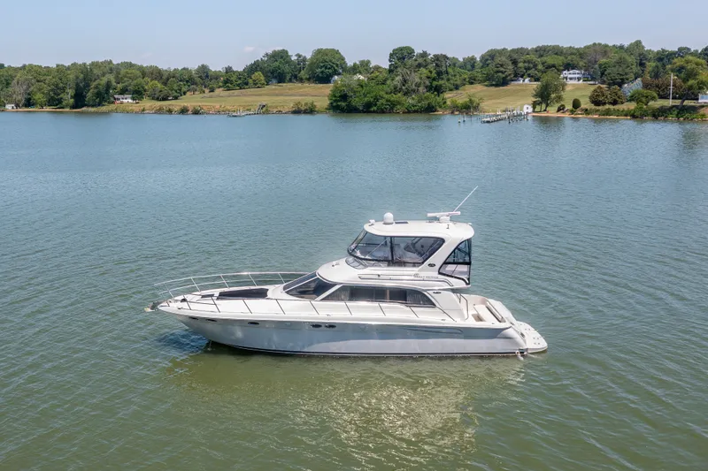 Slide: The Image of 2003 Sea Ray 480 Sedan Bridge on calm water. - 17
