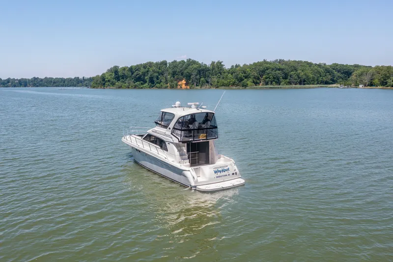 Slide: The Image of 2003 Sea Ray 480 Sedan Bridge on a calm lake. - 18