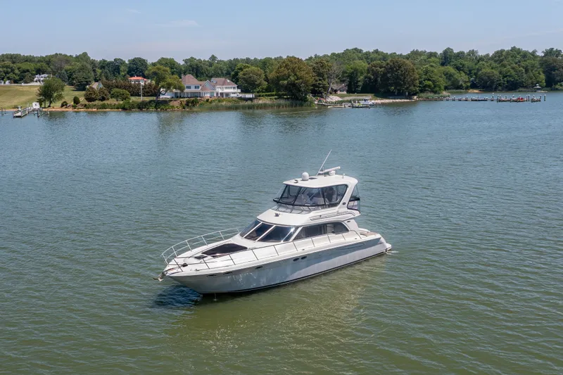 Slide: The Image of 2003 Sea Ray 480 Sedan Bridge on calm waters. - 19