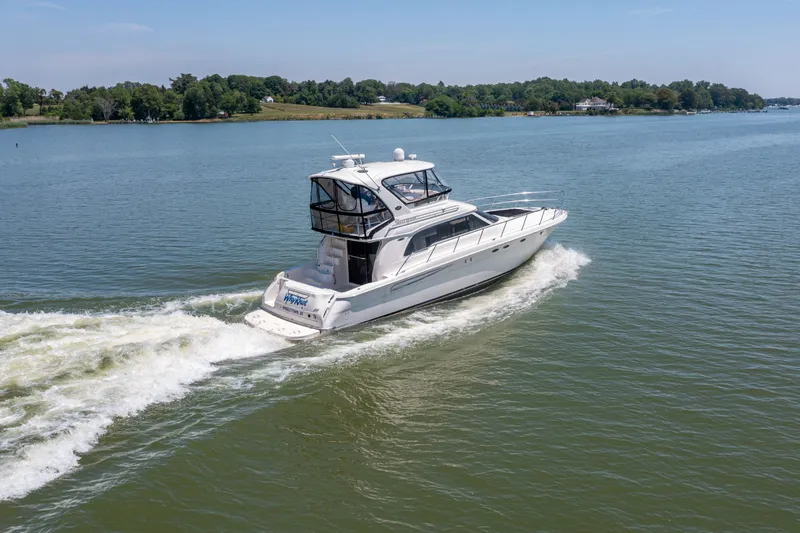 Slide: The Image of 2003 Sea Ray 480 Sedan Bridge cruising on calm waters. - 2