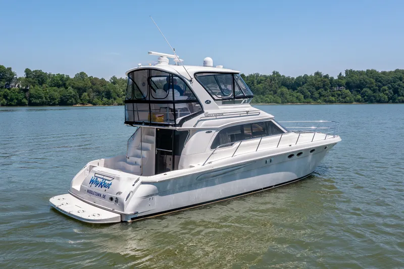 Slide: The Image of 2003 Sea Ray 480 Sedan Bridge on calm water. - 22