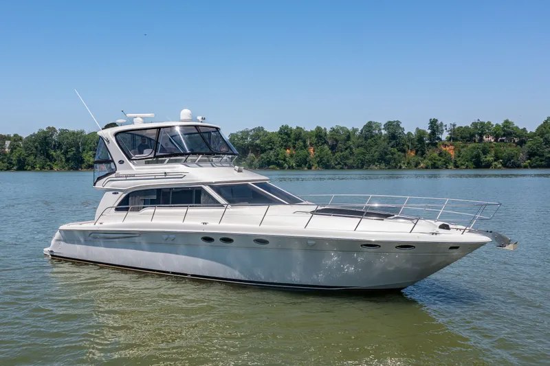 Slide: The Image of 2003 Sea Ray 480 Sedan Bridge on calm water. - 24