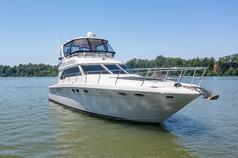 Slide: The Image of 2003 Sea Ray 480 Sedan Bridge on calm water. - 25
