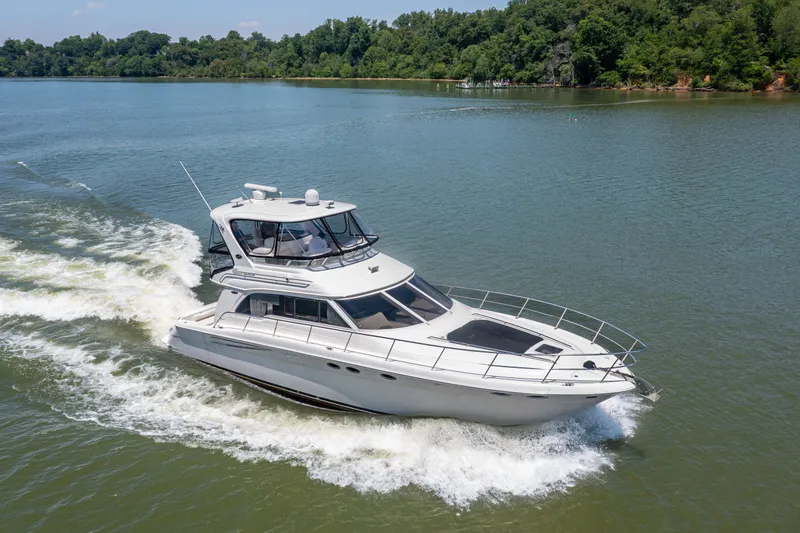 Slide: The Image of 2003 Sea Ray 480 Sedan Bridge cruising on a calm river. - 3