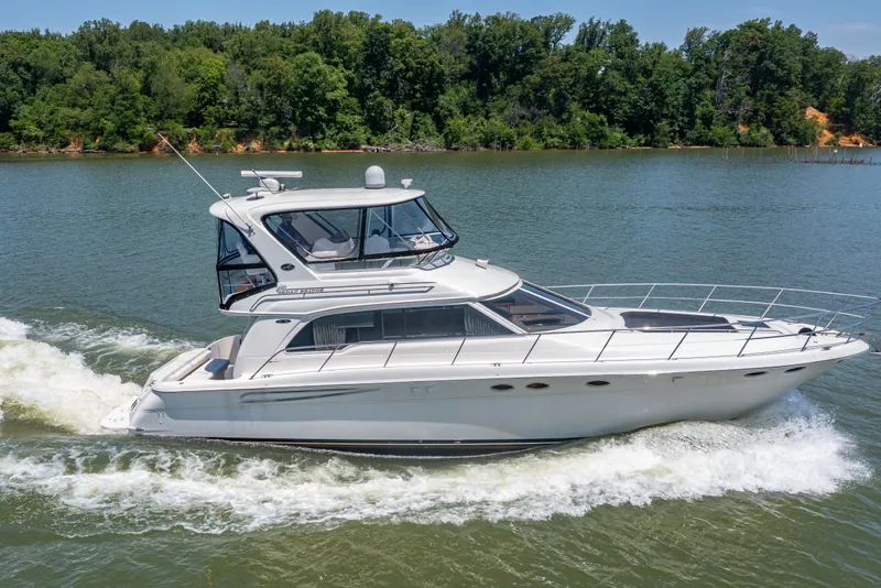 Slide: The Image of 2003 Sea Ray 480 Sedan Bridge cruising on a calm river. - 4