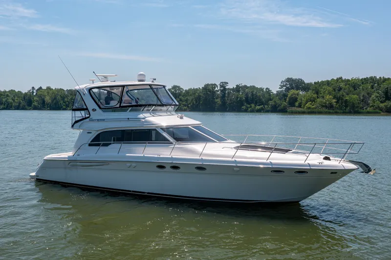 Slide: The Image of 2003 Sea Ray 480 Sedan Bridge on calm waters. - 5