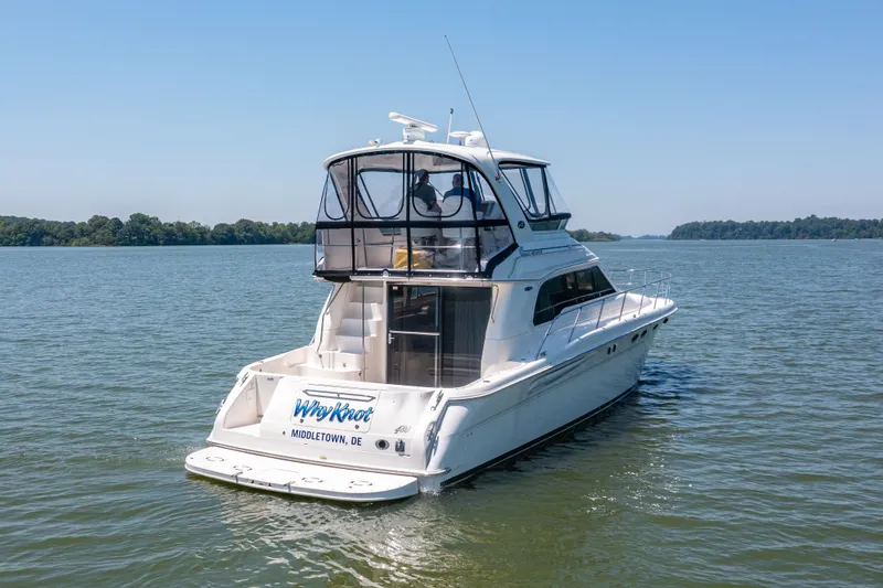 Slide: The Image of 2003 Sea Ray 480 Sedan Bridge on calm waters. - 7