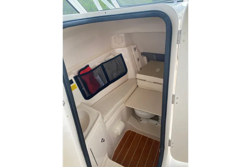 Slide: The Image of 2025 Grady-White Freedom 307 cabin interior with seating and storage. - 14