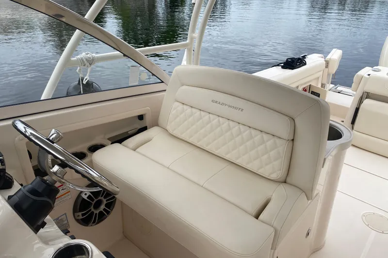 Slide: The Image of 2025 Grady-White Freedom 307 boat interior with luxurious seating and steering wheel. - 17
