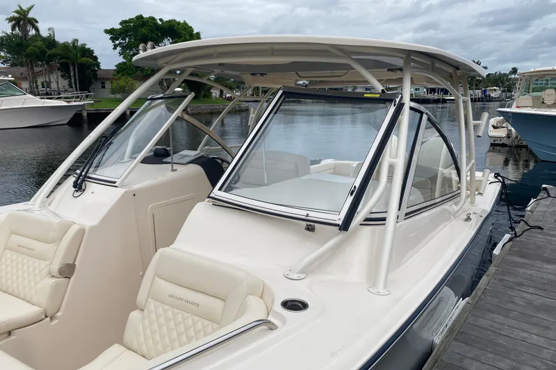 Slide: The Image of 2025 Grady-White Freedom 307 boat docked, featuring sleek design and comfortable seating. - 2
