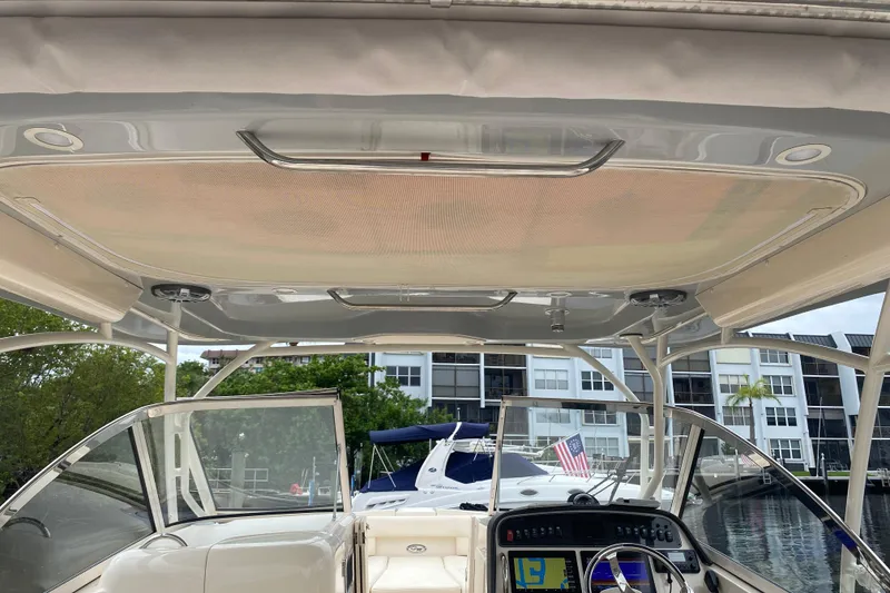 Slide: The Image of 2025 Grady-White Freedom 307 boat interior with helm and canopy view. - 5