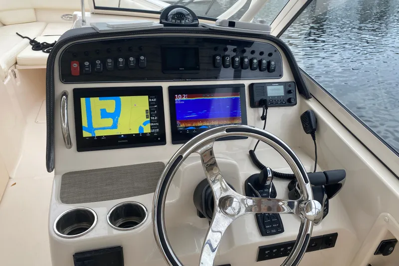Slide: The Image of Helm of 2025 Grady-White Freedom 307 boat with advanced navigation displays. - 8