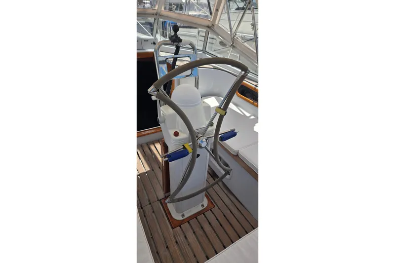 Slide: The Image of Steering wheel of a 1995 Contest 46/48 yacht on a wooden deck. - 10