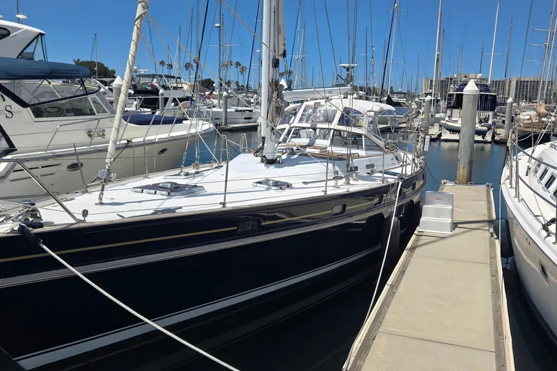 Slide: The Image of Sailboat Contest 46/48, 1995 model, docked in a marina under clear blue skies. - 14