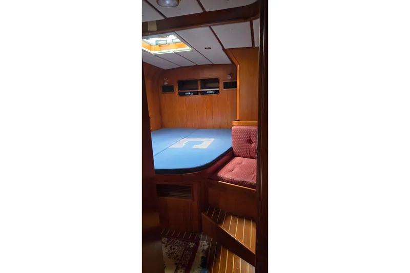 Slide: The Image of Cozy cabin interior of 1995 Contest 46/48 yacht with wooden paneling and blue bedding. - 24