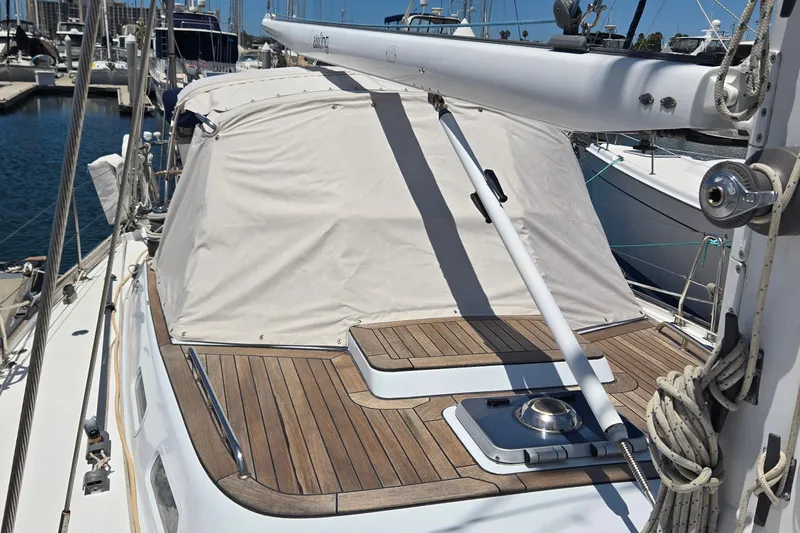 Slide: The Image of Sailboat deck with wooden finish, featuring a covered cockpit, Contest 46/48 model, 1995. - 13