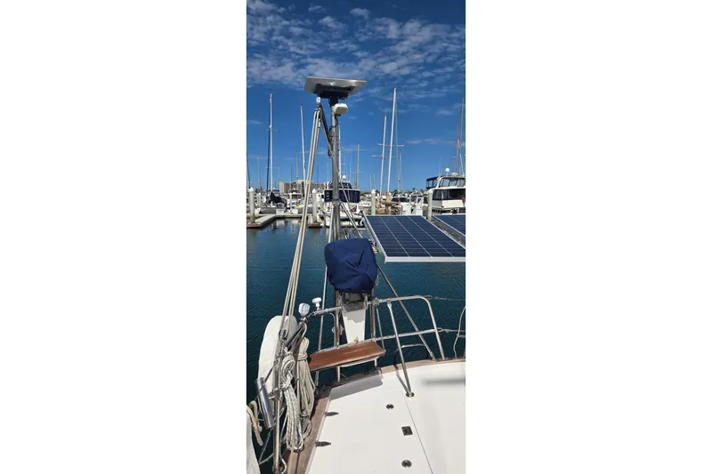 Slide: The Image of Sailboat Contest 46/48 (1995) docked in marina with solar panels and clear sky. - 8