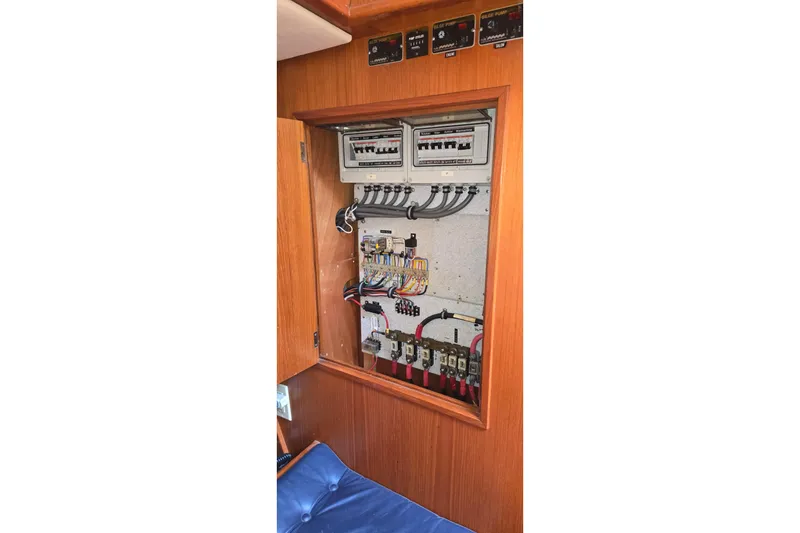 Slide: The Image of Electrical panel inside a 1995 Contest 46/48 yacht, showcasing wiring and circuit breakers. - 41