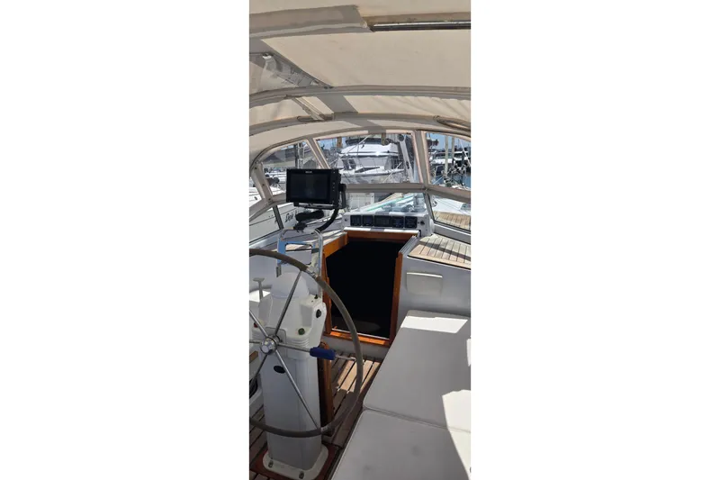 Slide: The Image of Interior view of a 1995 Contest 46/48 yacht cockpit with steering wheel and navigation equipment. - 19