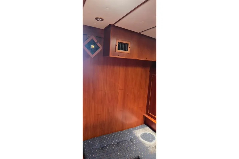 Slide: The Image of Wood-paneled interior of a 1995 Contest 46/48 yacht cabin with seating area. - 39