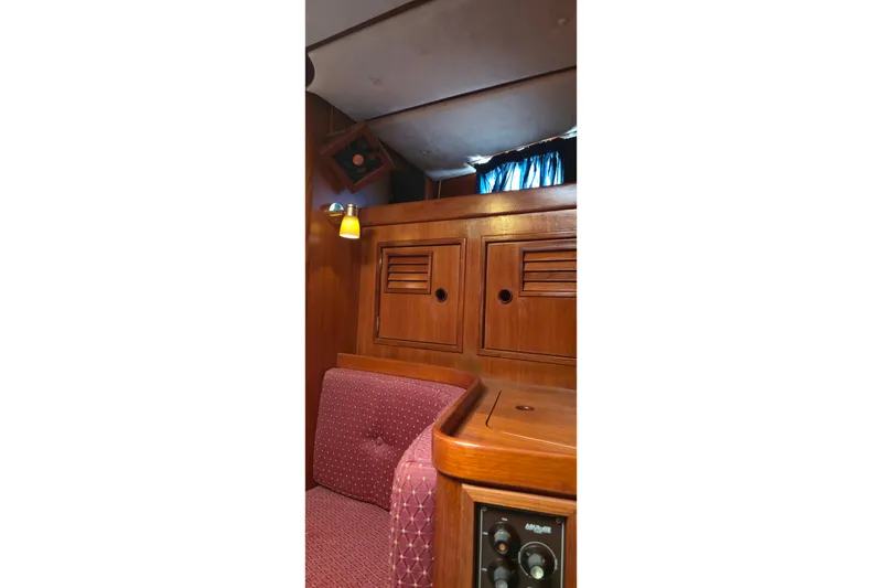 Slide: The Image of Interior of a 1995 Contest 46/48 yacht with wooden cabinetry and upholstered seating. - 27
