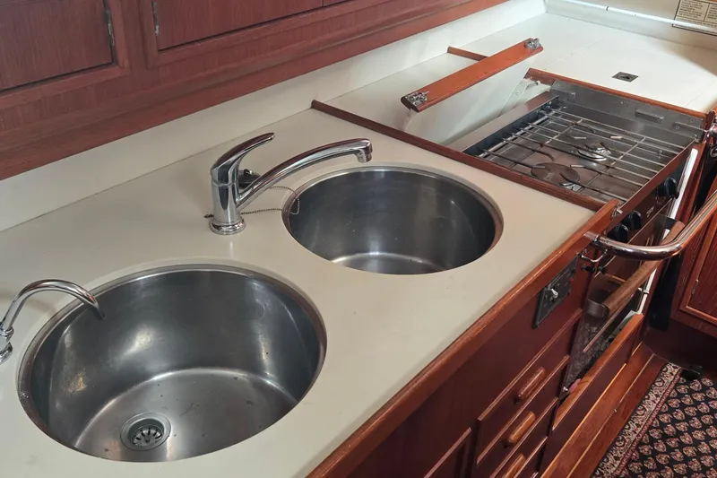 Slide: The Image of 1995 Contest 46/48 yacht kitchen with dual sinks and a gas stove. - 28