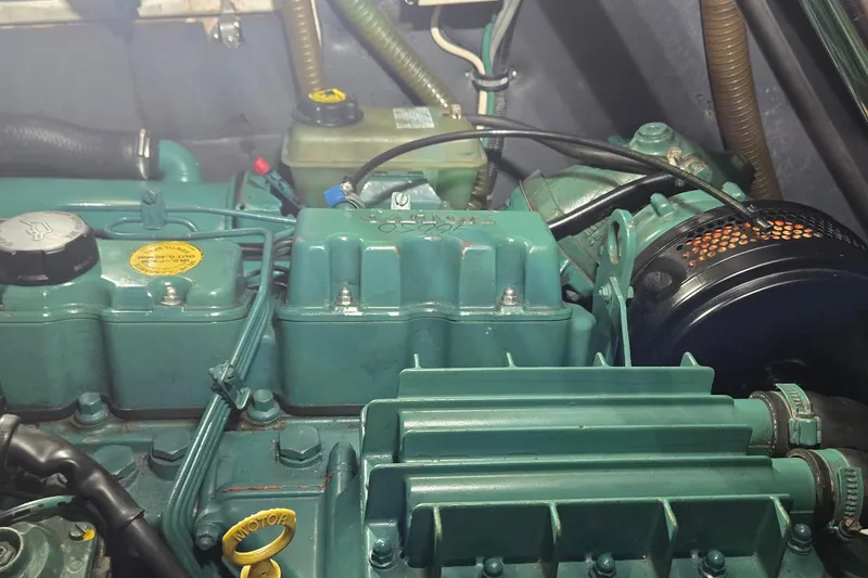 Slide: The Image of Engine compartment of a 1995 Contest 46/48, showcasing mechanical components and hoses. - 20