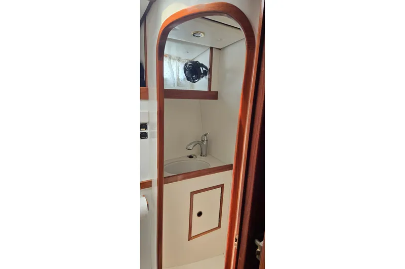 Slide: The Image of 1995 Contest 46/48 yacht bathroom with wooden trim and modern sink. - 26