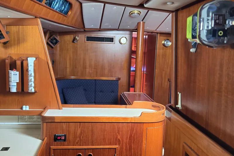 Slide: The Image of Interior of a 1995 Contest 46/48 yacht with wooden furnishings and cozy seating area. - 40
