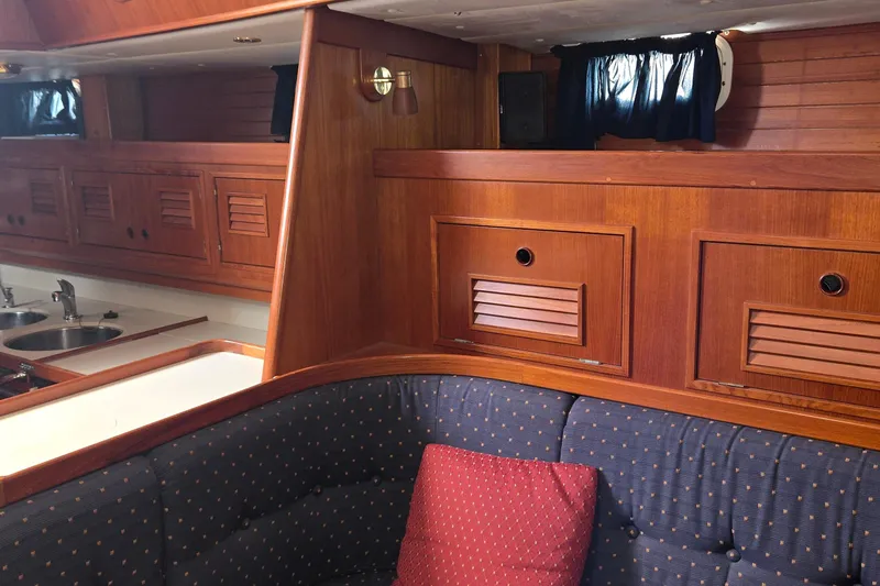 Slide: The Image of Interior of a 1995 Contest 46/48 yacht with wooden cabinetry and cozy seating. - 43