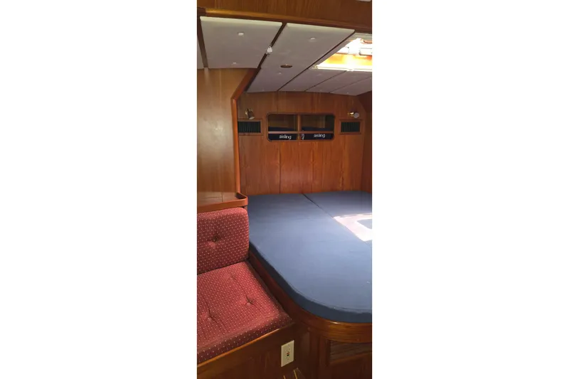 Slide: The Image of Interior cabin of a 1995 Contest 46/48 yacht with wooden paneling and blue bedding. - 23