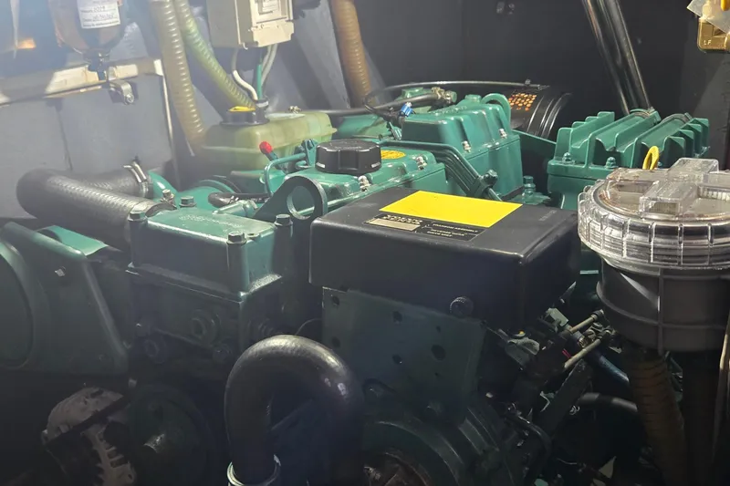 Slide: The Image of Engine room of a 1995 Contest 46/48 yacht, showcasing mechanical components and systems. - 21