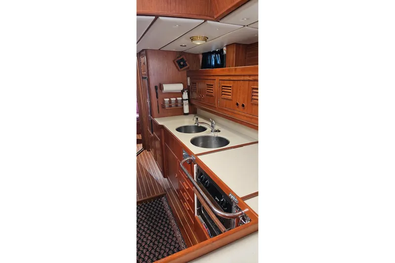 Slide: The Image of Luxurious 1996 Contest 46/48 yacht interior with wooden cabinetry and modern kitchen amenities. - 22