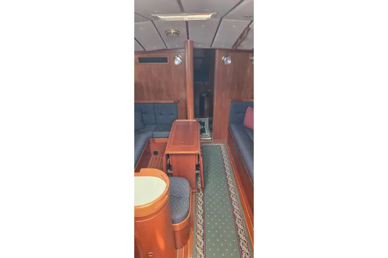 Slide: The Image of Interior of a 1996 Contest 46/48 yacht with wooden furnishings and seating. - 11