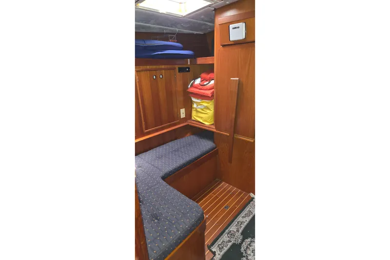 Slide: The Image of Interior of 1996 Contest 46/48 yacht with wooden cabinetry and cushioned seating. - 12